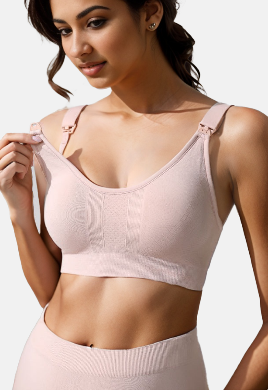 "Model demonstrating the front clasp on a dusty pink nursing bra for easy access"
