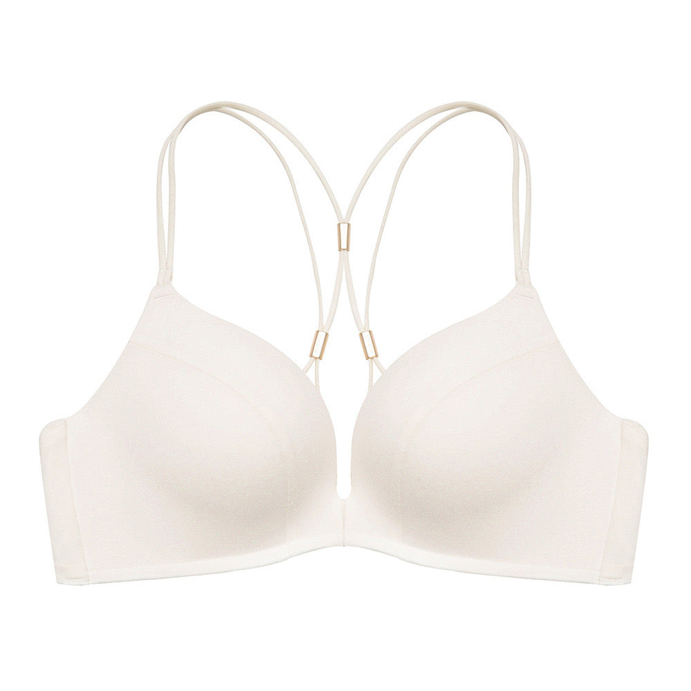 "Cream-colored front-open seamless bra with minimalistic design and decorative back straps"