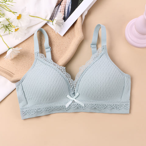 Ash blue stretchy and breathable bralette with lace detail and front bow, designed for youthful comfort and everyday wear, presented in a natural setting with daisies and lifestyle elements.