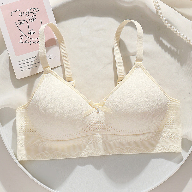 Cream bra with a lift and side spillage protection, featuring hollow-out breathable cups for daily wear