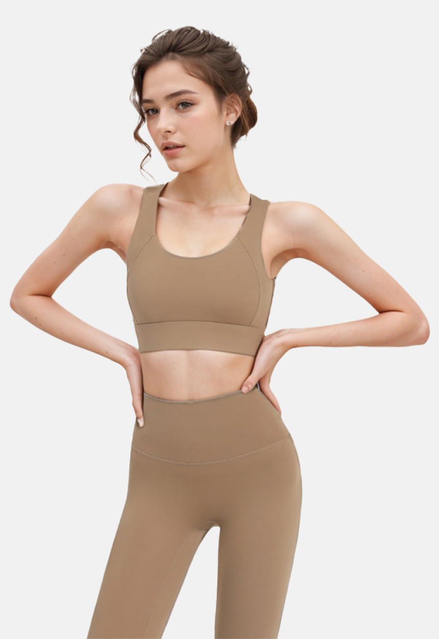 Tan sports bra top and leggings on model, featuring brown sports bra, yoga bra, absorbing gathering sports bra.