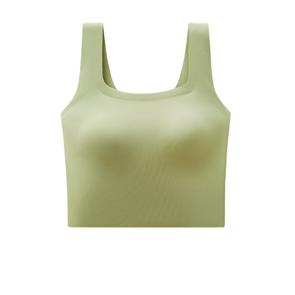 Green training bra for girls on hanger showing the built-in bra feature