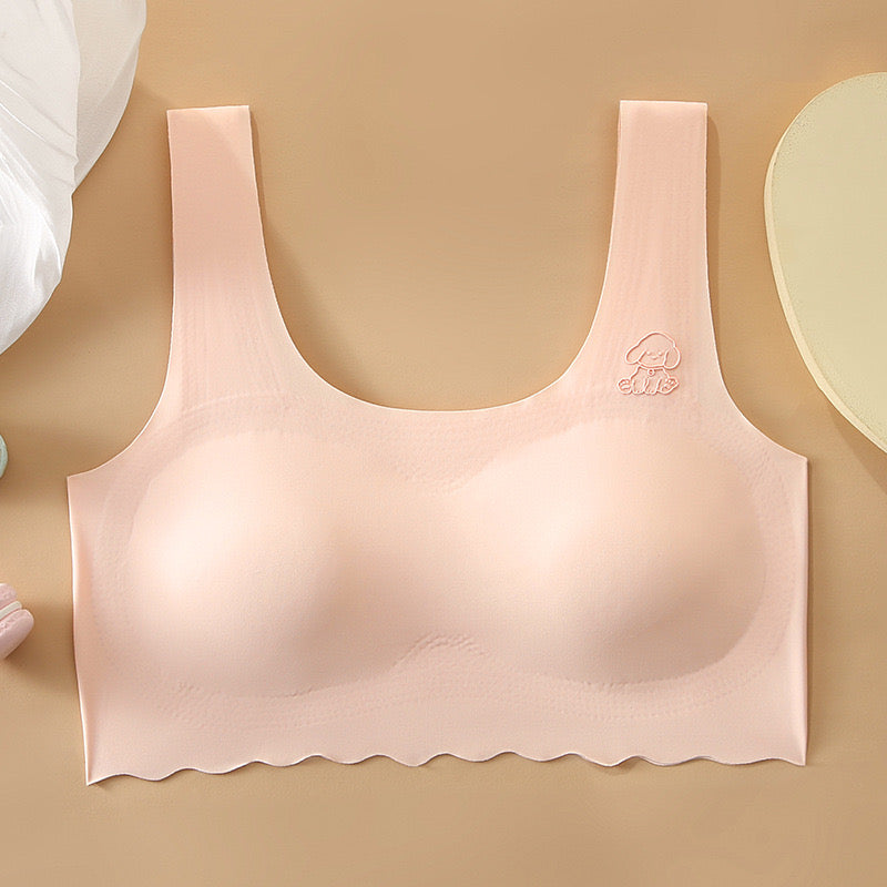 Close-up of seamless peach developmental vest bra with a fixed one-piece cup and adorable dog detail by ucharm bras