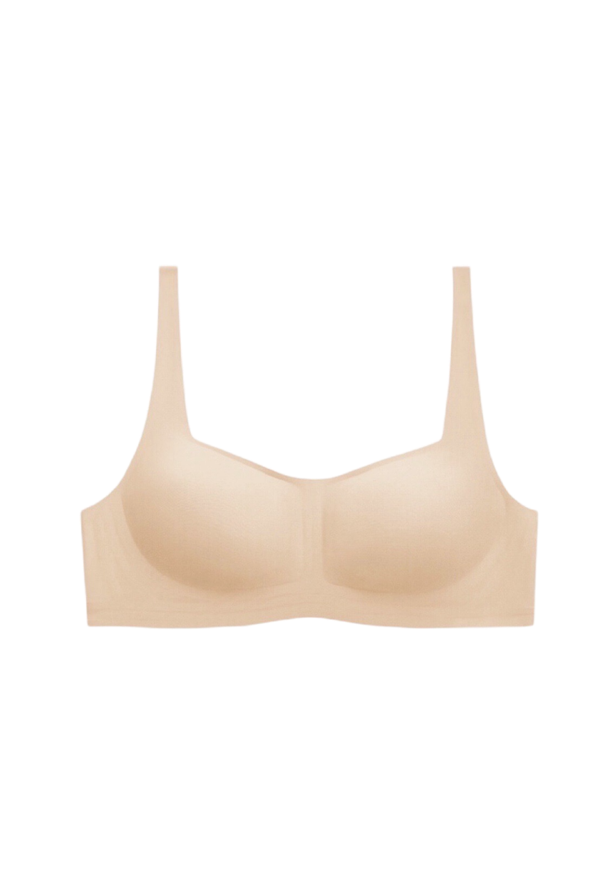 Neutral beige wireless bra with 1/2 cup coverage and one-piece supportive construction, crafted with high-elasticity fibers for a gentle feel.