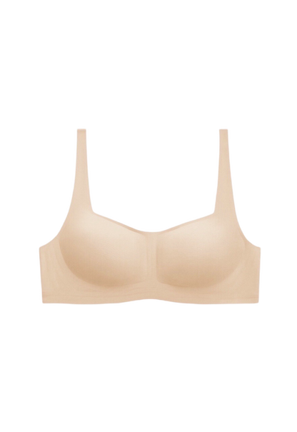 Neutral beige wireless bra with 1/2 cup coverage and one-piece supportive construction, crafted with high-elasticity fibers for a gentle feel.