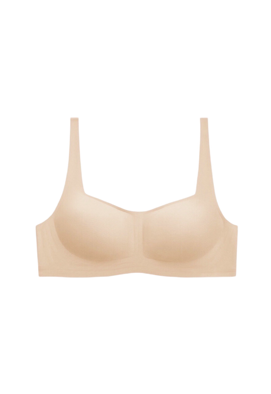 Neutral beige wireless bra with 1/2 cup coverage and one-piece supportive construction, crafted with high-elasticity fibers for a gentle feel.