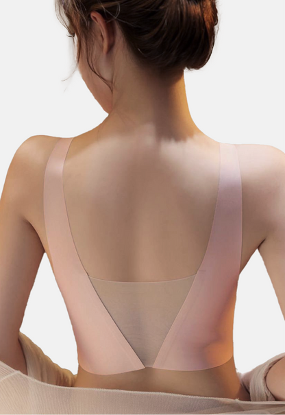 "Rear view of a woman wearing a beige V-mesh comfort bra highlighting the deep V-back detail"