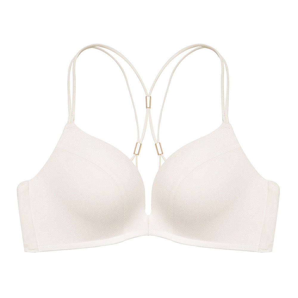 "Cream-colored front-open seamless bra with minimalistic design and decorative back straps"