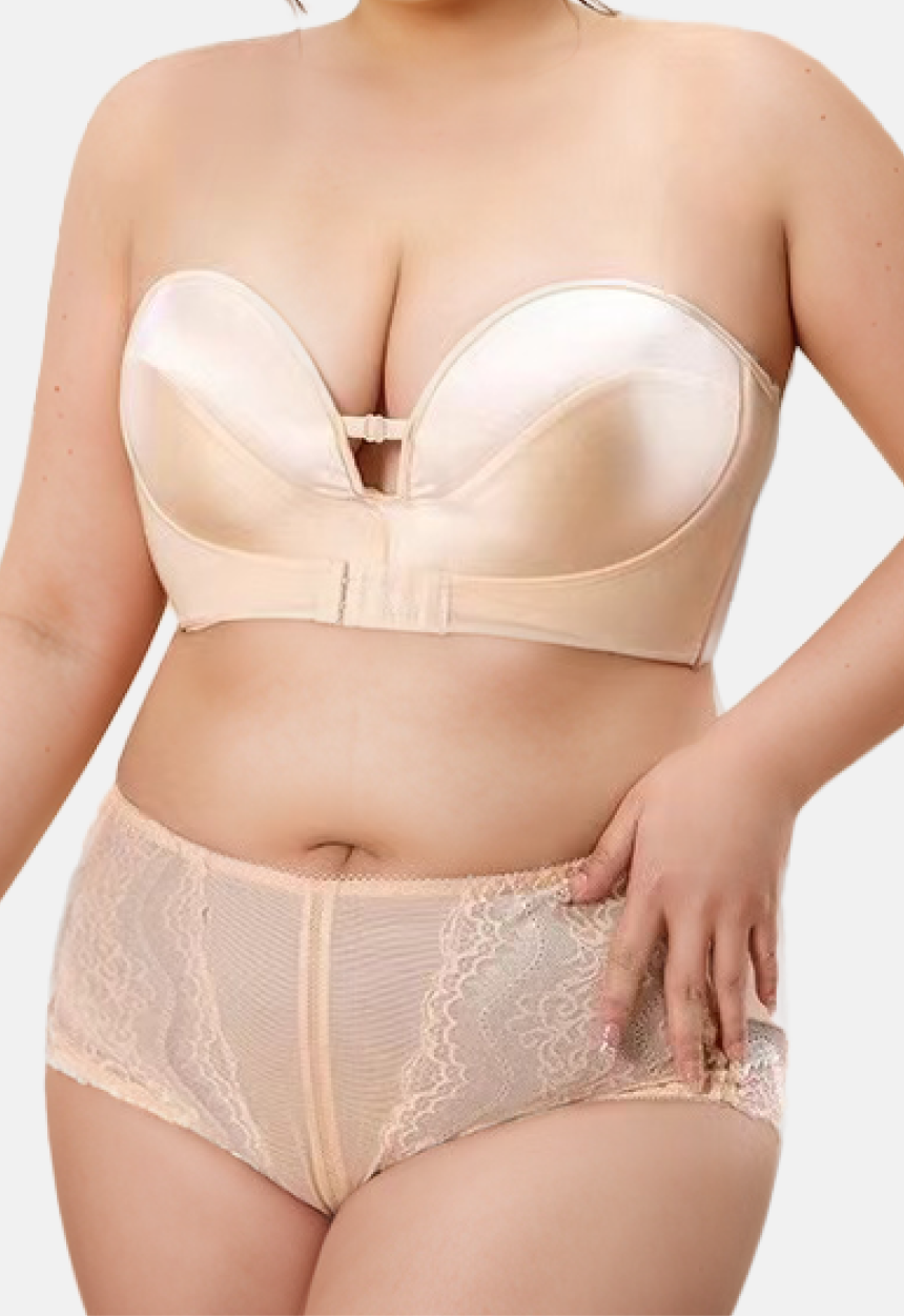 "Front view of a smiling woman wearing a plus-size strapless beige bra with a lifting design"