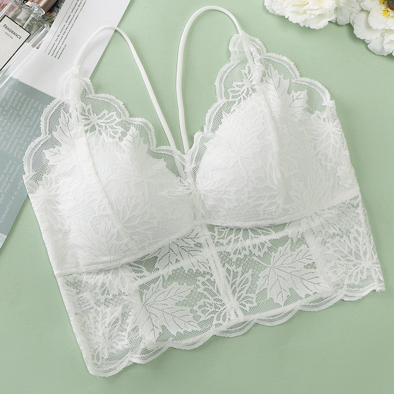 White lace bralette featuring intricate leaf designs and scalloped edges.