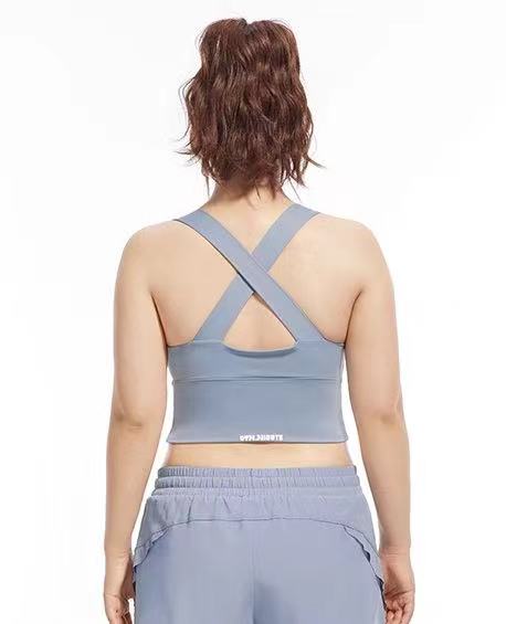 back view of a model in blue cross back yoga sport bra from ucharm sotre